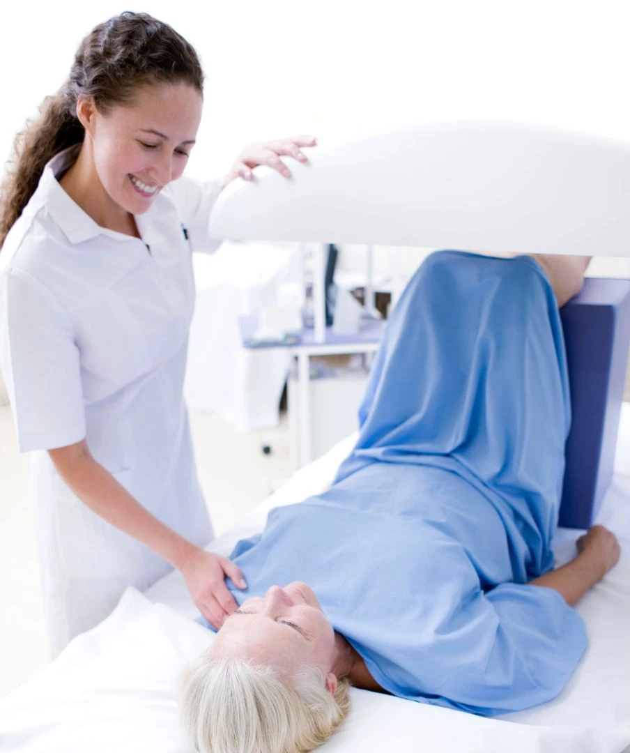A nurse assists a patient in bed at a weight loss clinic in Vancouver.