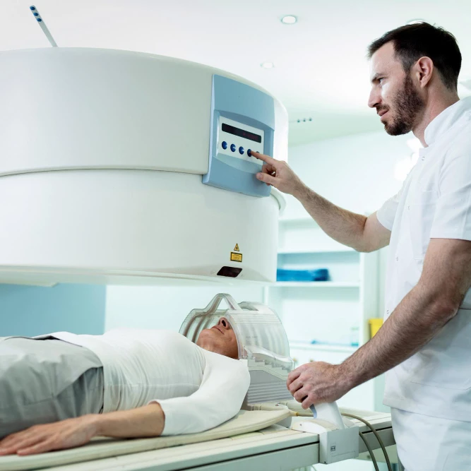 A doctor is examining a patient in an MRI machine at a Weight Loss Clinic in Vancouver.